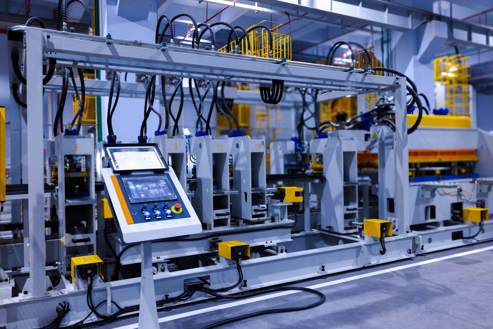 Engineer monitoring an automated production line on a tablet